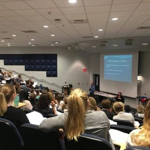 A seated audience attending an ArizOTA conference presentation.