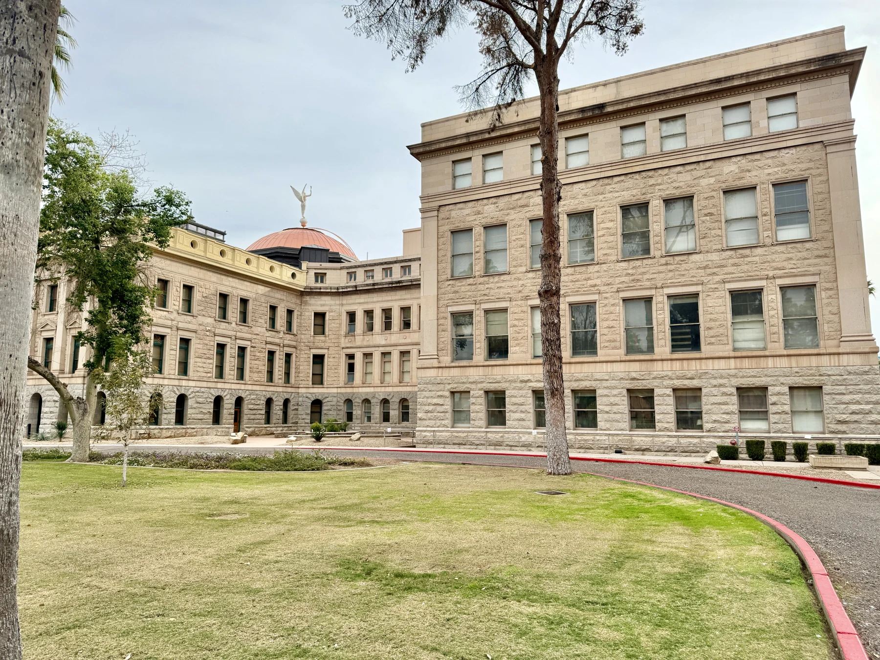 Another view of the Arizona State Capitol, showing its historic stone exterior and copper dome.